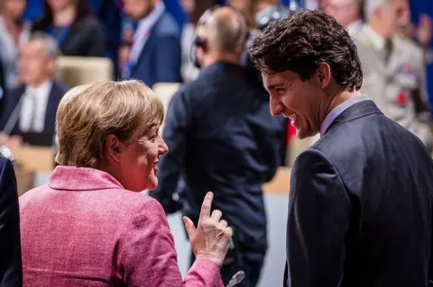 Getty Images Angela Merkel and Justin Trudeau at the Nato summit in Warsaw in July 2016