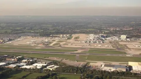 An aerial shot of Gatwick Airport showing the runways and terminal buildings