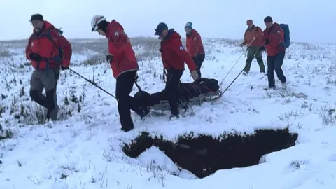 A casualty is transported to an ambulance