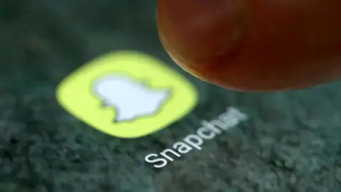 REUTERS A finger hovering over the snapchat app logo