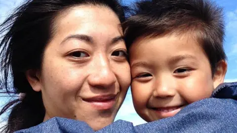 Family photo Christine Hui and William Gray hugging one another