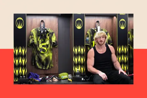 Getty Images Logan Paul, a muscular man with peroxide blonde hair, wearing a black vest while sitting in a locker room