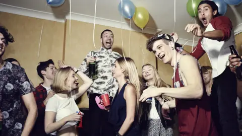 Getty Images Young adults at a house party