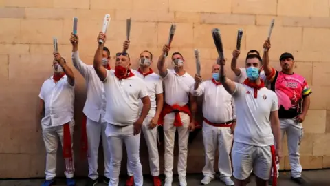 Reuters The traditional running of the bulls was cancelled but these traditional singers turned up for the first day