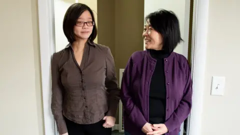 Eiling Chao, shown with her daughter Stephanie, standing in a doorway