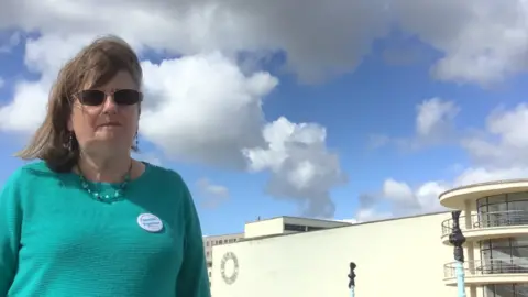 Claire Baldry, a candidate, standing in front of the De La Warr pavilion