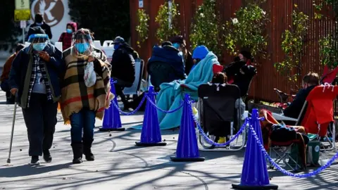 Getty Images People without appointments waiting in line for the potential chance to receive a Covid-19 vaccination in Los Angeles, California