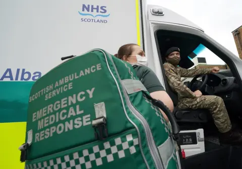 PA Media Paramedic with soldier at ambulance