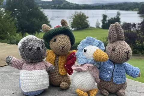 Clare Skeggs Four crochet figures on a bench