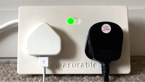 A smart socket with a green light.