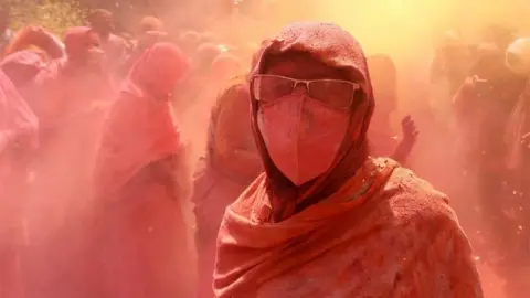 EPA Indian widows participate in the Holi festival in Vrindavan, Uttar Pradesh, India, 15 March 2022.