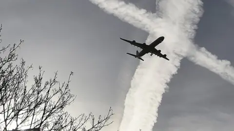 Reuters Plane silhouette and contrails
