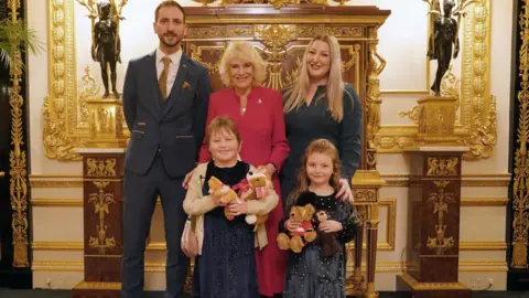 PA Media Queen Camilla with Olivia Taylor (front left) from south-east London next to her sister Imogen, father Matt and mother Lisa at Windsor Castle