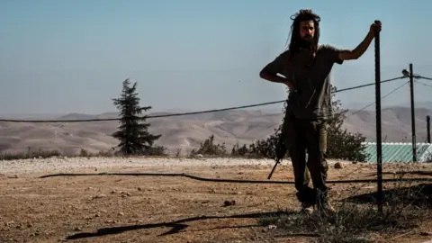 Getty Images An armed Israeli settler pictured in November