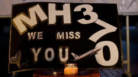 AFP/Getty A message says: "MH370 we miss you"