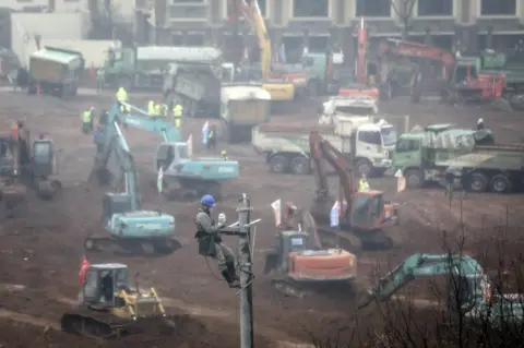 Getty Images A view of cranes and diggers building Huoshenshan Hospital