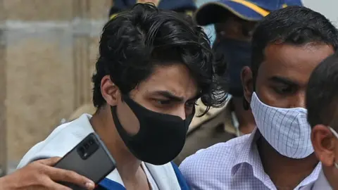 Getty Images Aryan Khan (C), son of Bollywood actor Shah Rukh Khan