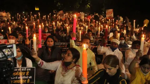 Getty Images Activists of the Indian Youth Congress took out a candle light march at Jantar Mantar demanding justice for the Hathras gang-rape victim, who died at a government hospital in Delhi last month, on October 12, 2020 in New Delhi, India.