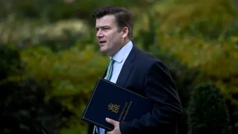 TOBY MELVILLE Man with suit walking into Number 10 Downing Street