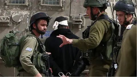 AFP Palestinian arrested by Israeli soldiers (file photo)