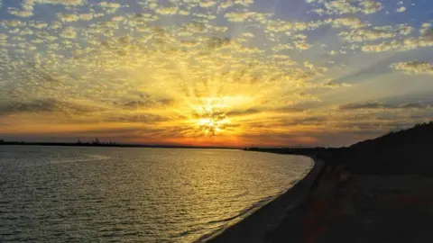 Ricky Howitt The sun and clouds almost looks like an explosion in this picture.