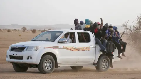 Reuters Migrants crossing the Sahara desert into Libya ride on the back of a pickup truck outside Agadez, Niger, May 2016