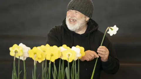 Danny Lawson / PA Media Man arranging flowers at Harrogate Flower Show