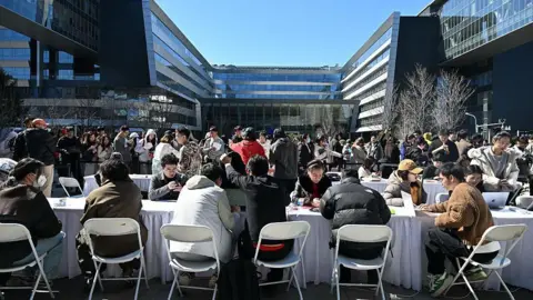 AFP via Getty Images Engineers (front) install and set OpenClaw, an open-source AI assistant at the Baidu headquarter in Beijing on March 11, 2026