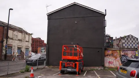 PA Media Wall painted black on Port Street in Manchester