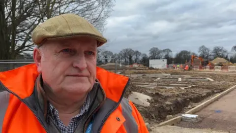 ANDREW TURNER/BBC Councillor Alistair Beales stands on the edge of the Florence Fields development off Parkway in King's Lynn.
