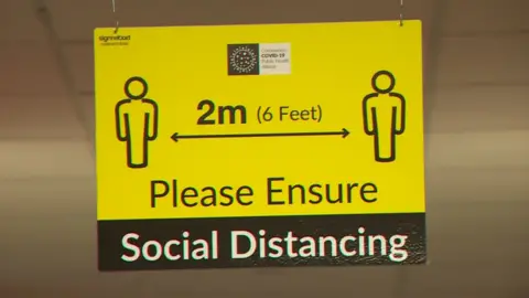 SIGN THAT SAYS '2M - PLEASE ENSURE SOCIAL DISTANCING'