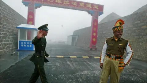 AFP In this photograph taken on July 10, 2008 a Chinese soldier (L) and an Indian soldier stand guard at the Chinese side of the ancient Nathu La border crossing between India and China