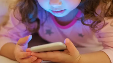 Getty Images Anonymous child using a smartphone