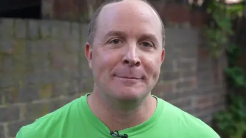 Mr Dorsett, a man wearing a bright green t-shirt.