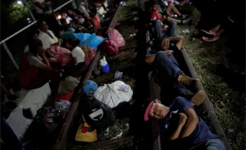 Reuters Honduran migrants rest on the bridge that links Mexico and Guatemala, in Ciudad Hidalgo, Mexico