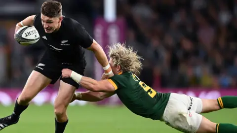 Beauden Barrett tackled by Faf de Klerk