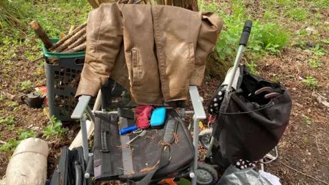 Some of the other items found at the site, including a trolley and clothing, as well as a leather coat, a bag and cutlery.