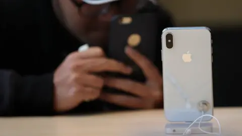 Getty Images A customer takes a picture of the new iPhone X at an Apple Store on November 3, 2017 in Palo Alto, California.