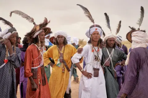 AFP A group of Wodaabe men rest after dancing during the Cure Salee, in Ingall, northern Niger, on 18 September.