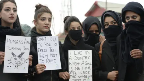 AFP Kashmiri law students hold placards during a protest calling for justice following the rape and murder of an eight-year-old girl in the Indian state of Jammu and Kashmir, in Srinagar on 18 April, 2018