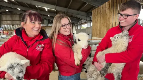 BBC Staff at Rand Farm Park with lamb triplets