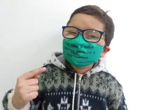Ana Maria Manzanares Francisco wears a mask reading "boys and girls have the right to free speech"