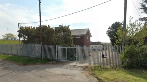 FCC Environment site at Buckden, showing locked gate and hedging