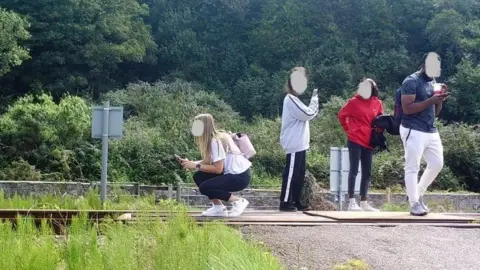 Network Rail Teenager in Harlech pose for selfies on a level crossing