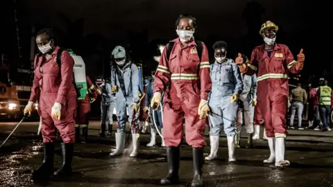 AFP A market being disinfected in Nairobi at night, 15 April 2020