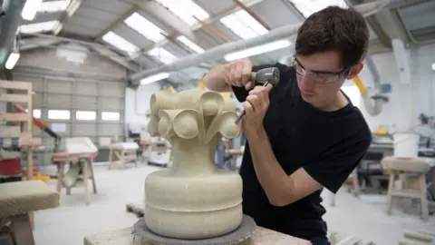 Getty Images A recently graduated apprentice stonemason