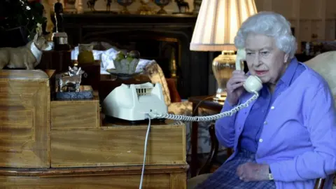 Buckingham Palace handout The Queen speaking to Boris Johnson on the phone