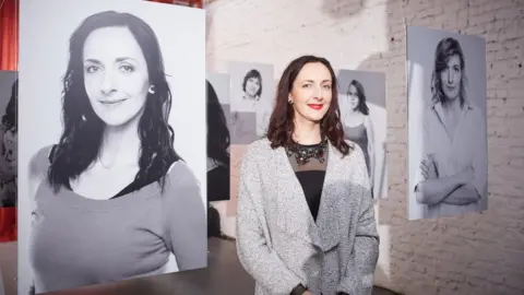 UNFPA/Maxim Ermolenko The victim of domestic abuse Olga in front of the portraits