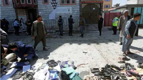 Reuters Clothes and sandals are seen at the site of a suicide bomb attack in Kabul, Afghanistan (April 22, 2018)