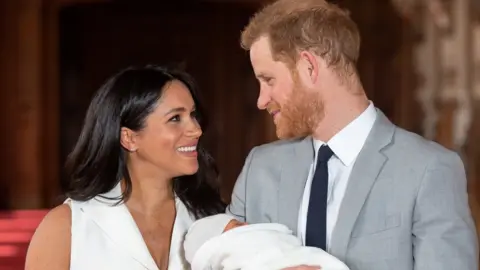 Reuters Britain"s Prince Harry and Meghan, Duchess of Sussex hold their baby son, who was born on Monday morning,